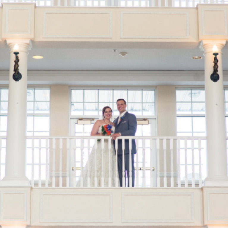 BRIDE AND GROOM ON BALCONY AT BLUE HARBOR RESORT WEDDING