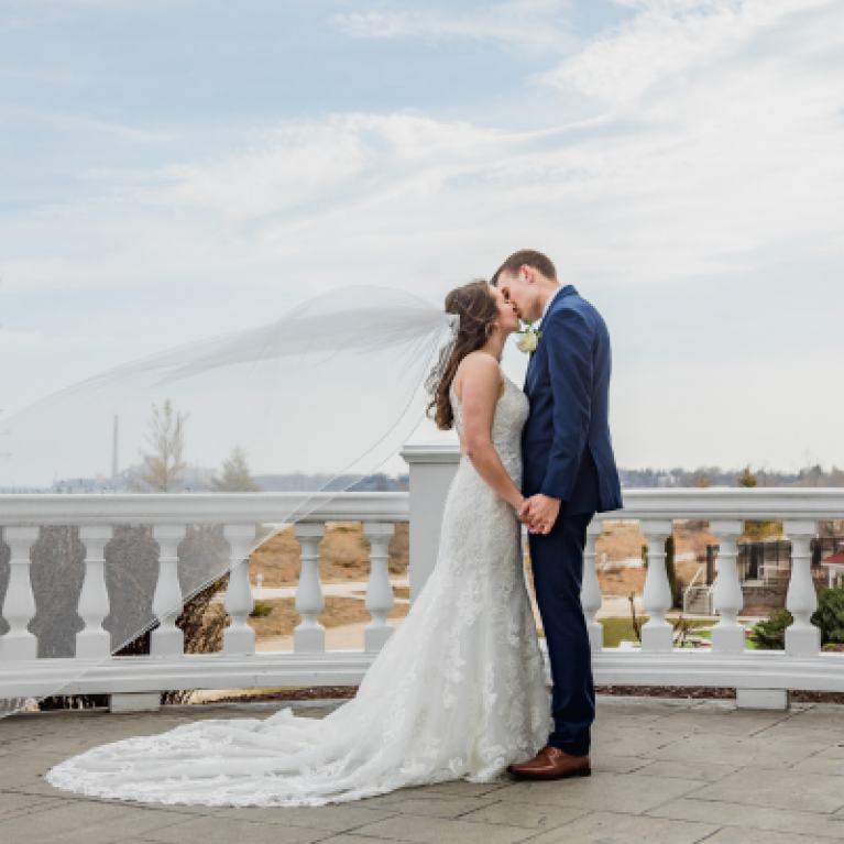 BRIDE AND GROOM ON PATIO AT BLUE HARBOR RESORT WEDDING